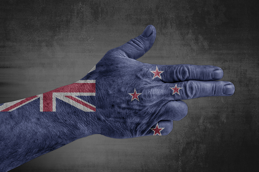 New Zealand flag painted on male hand like a gun