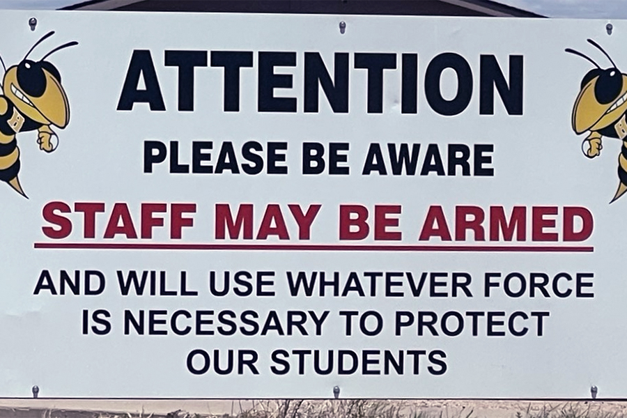 school staff armed sign feat