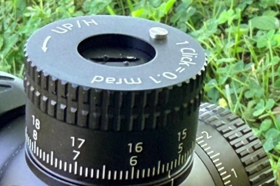 A small silver pin sticking up from a black dial on a scope, showing it has been turned a full circle. German Precision Optics Centuri 4x16 Compact Scope