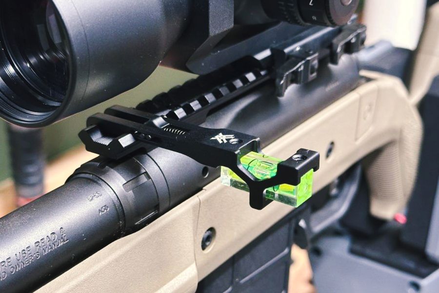 A brown rifle with a black scope on it and a green level sticking off to the side. German Precision Optics Centuri 4x16 Compact Scope